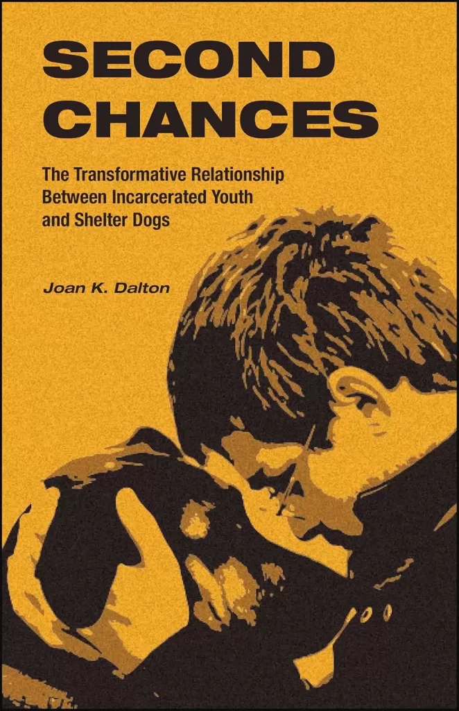 Book cover with orange background: SECOND CHANCES The Transformative Relationship Between Incarcerated Youth and Shelter Dogs. By Joan K. Dalton.